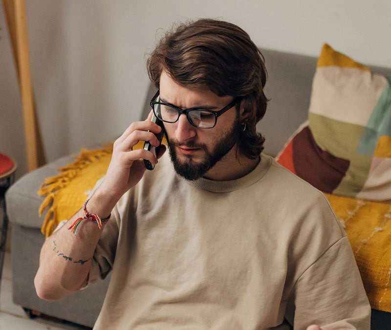 A man testing his phone, suspecting it may be tapped.
