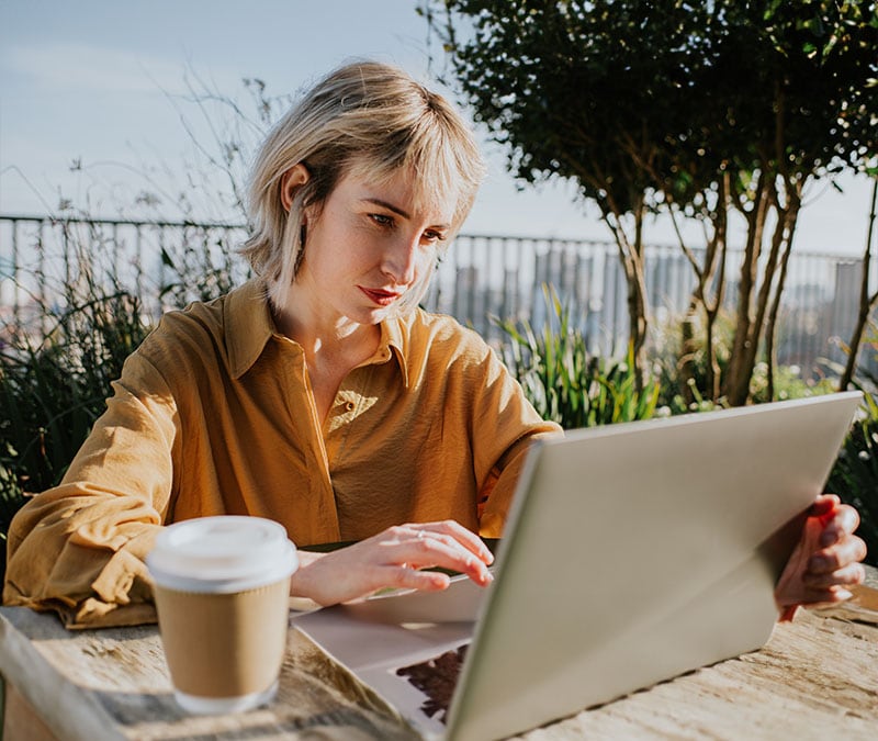 A person looking at their computer screen in confusion, trying to identify a Norton email scam.