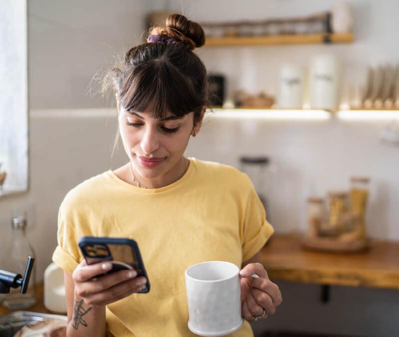 A woman reviews her phone settings to turn off the microphone.