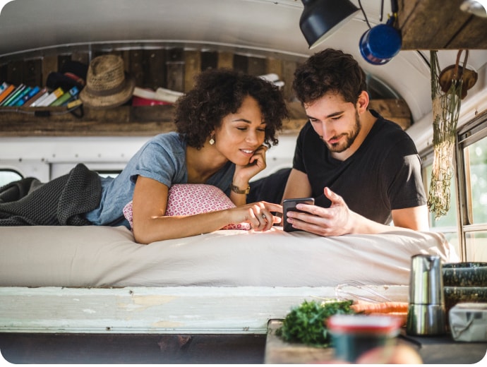 Woman and a man looking at a mobile phone.