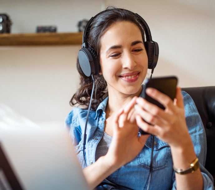 Lady smiling listening to music Ultimate Help Desk.