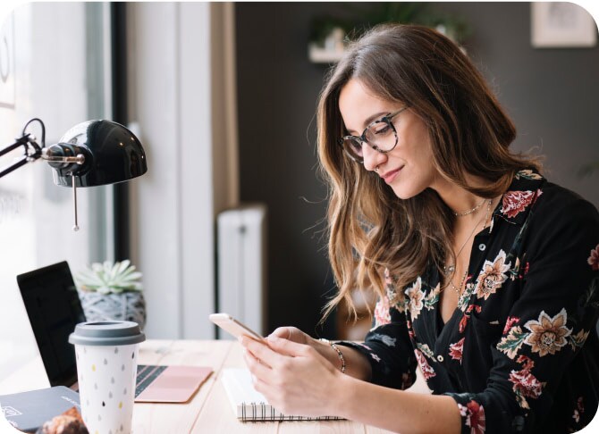 Woman in her office checking her phone